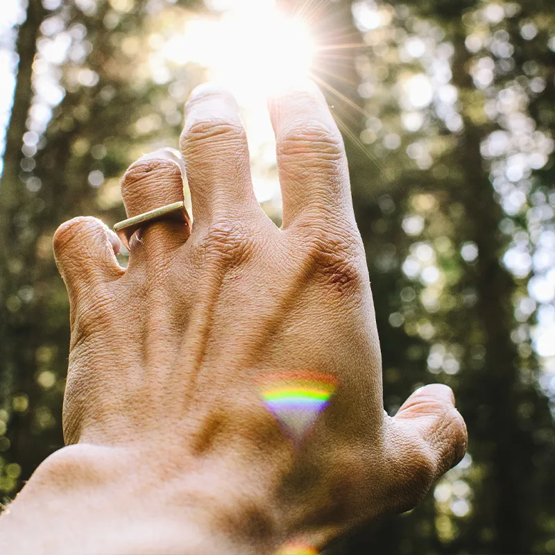 hand reaching for a light beam